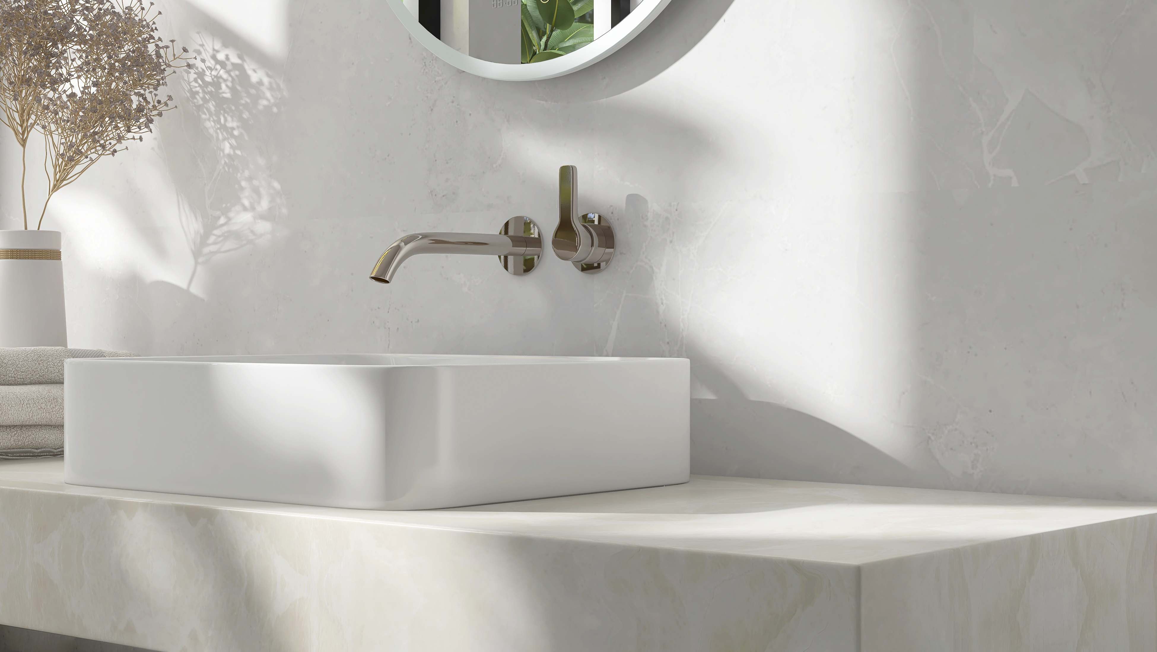 Modern white bathroom sink with wall-mounted chrome faucet and round mirror